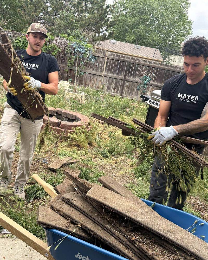 Mayer Enterprises crew clearing backyard debris in Denver