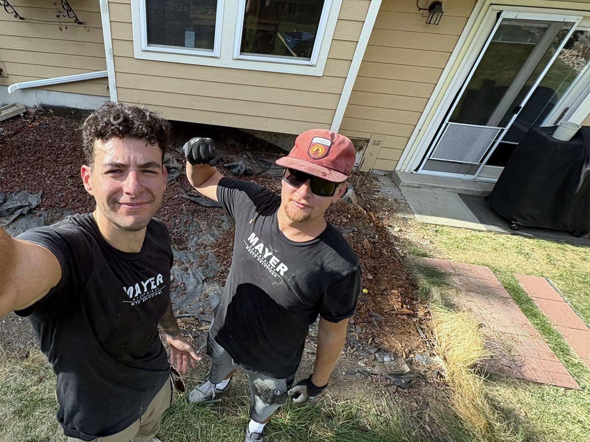 The Mayer Enterprises crew in branded shirts on a deck demolition job in Arvada
