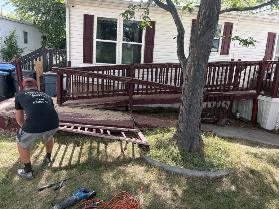 Railing section pulled off a wheelchair ramp during removal at a manufactured home in Golden, Colorado
